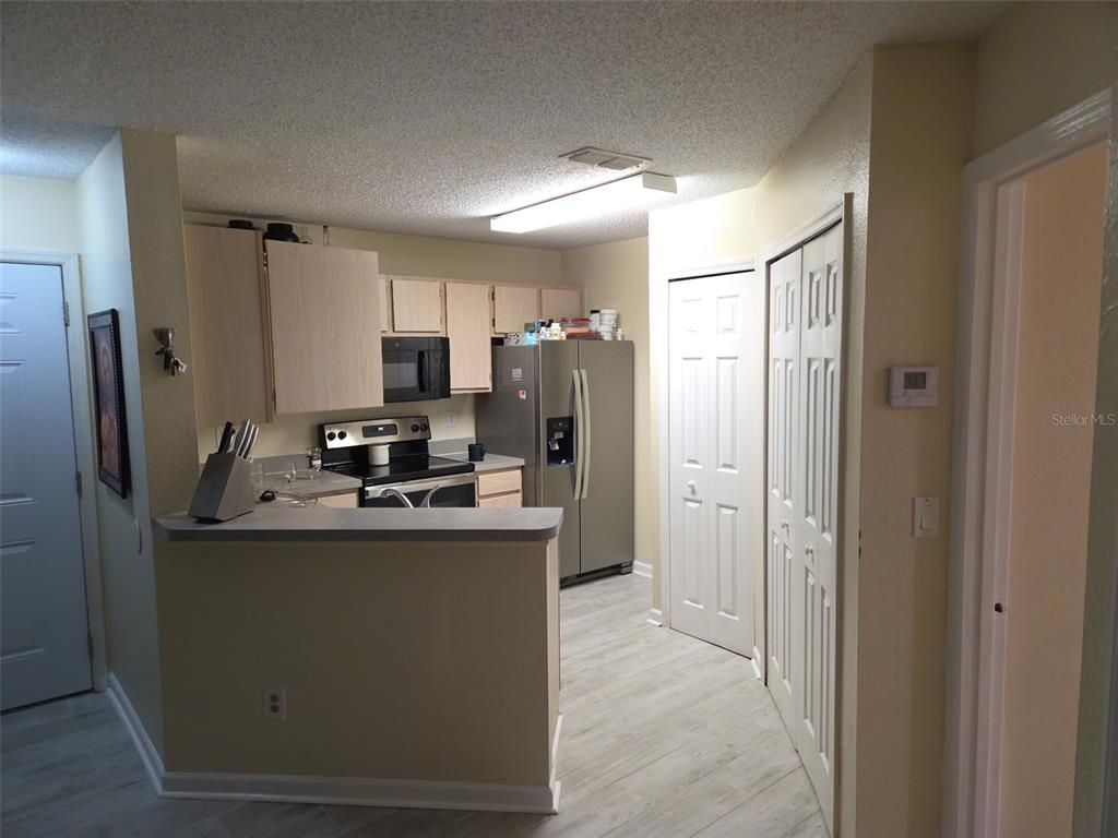3705 Southwest 27th Street, Unit 422 Gainesville, FL 32608 - Photo 21 of 25 a kitchen with stainless steel appliances granite countertop a refrigerator stove and sink