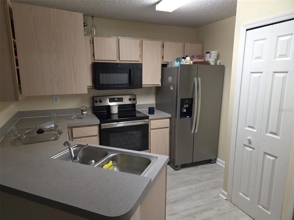 3705 Southwest 27th Street, Unit 422 Gainesville, FL 32608 - Photo 24 of 25 a kitchen with a refrigerator sink and microwave
