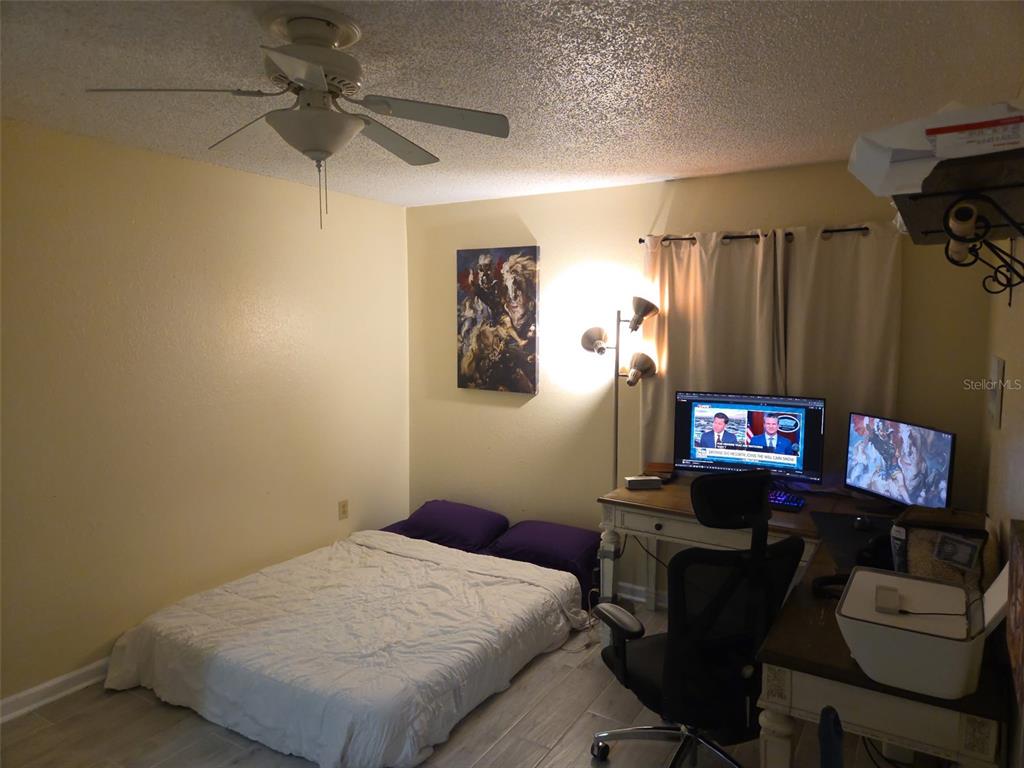 3705 Southwest 27th Street, Unit 422 Gainesville, FL 32608 - Photo 25 of 25 a bedroom with a bed and a flat screen tv