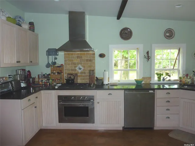 a kitchen with stainless steel appliances a stove and cabinets
