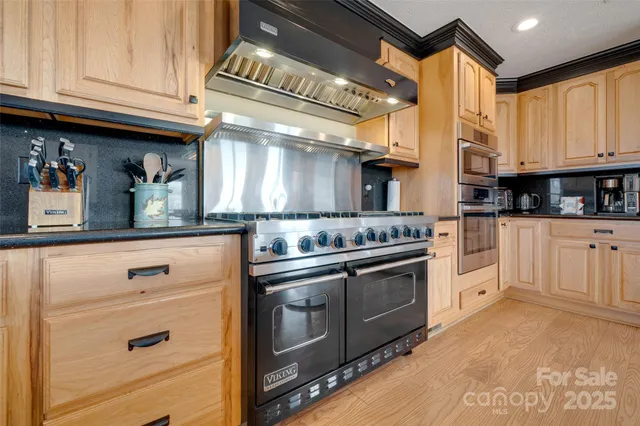a kitchen with stainless steel appliances a refrigerator and a stove top oven