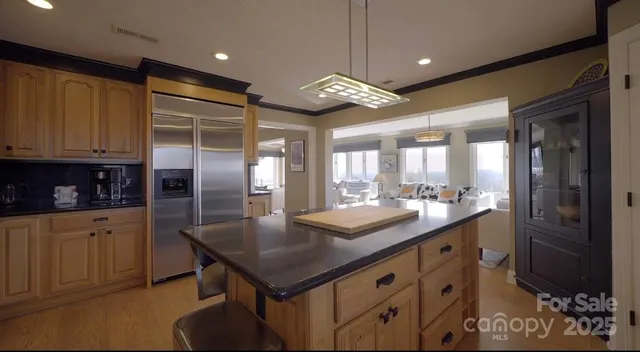 a living room with patio fireplace furniture and a large window