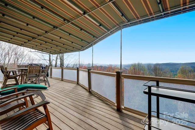 a view of a balcony with table and chairs