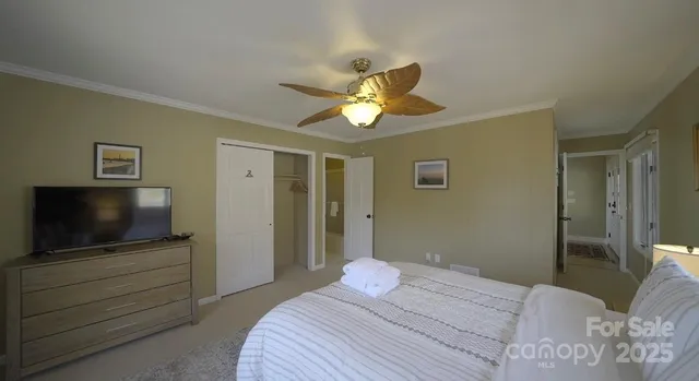 a bedroom with a bed and a chandelier