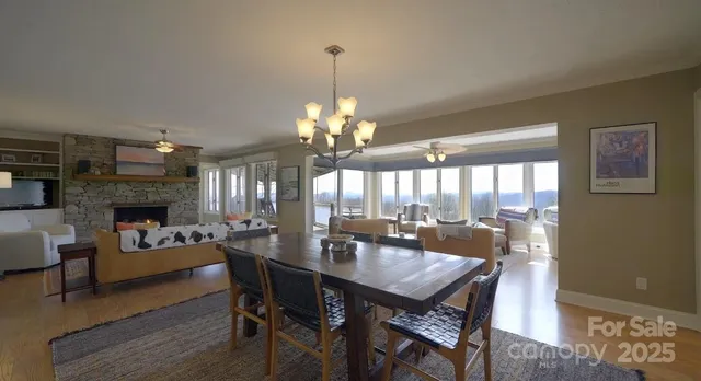 a view of a dining room with furniture a chandelier and wooden floor