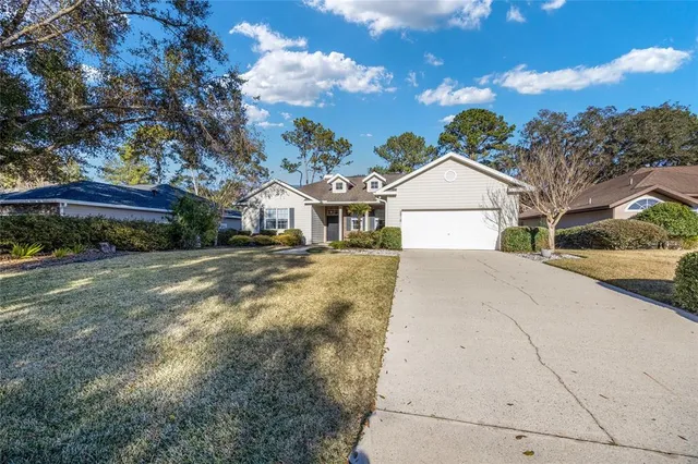 a view of a brick house with a large windows and plants