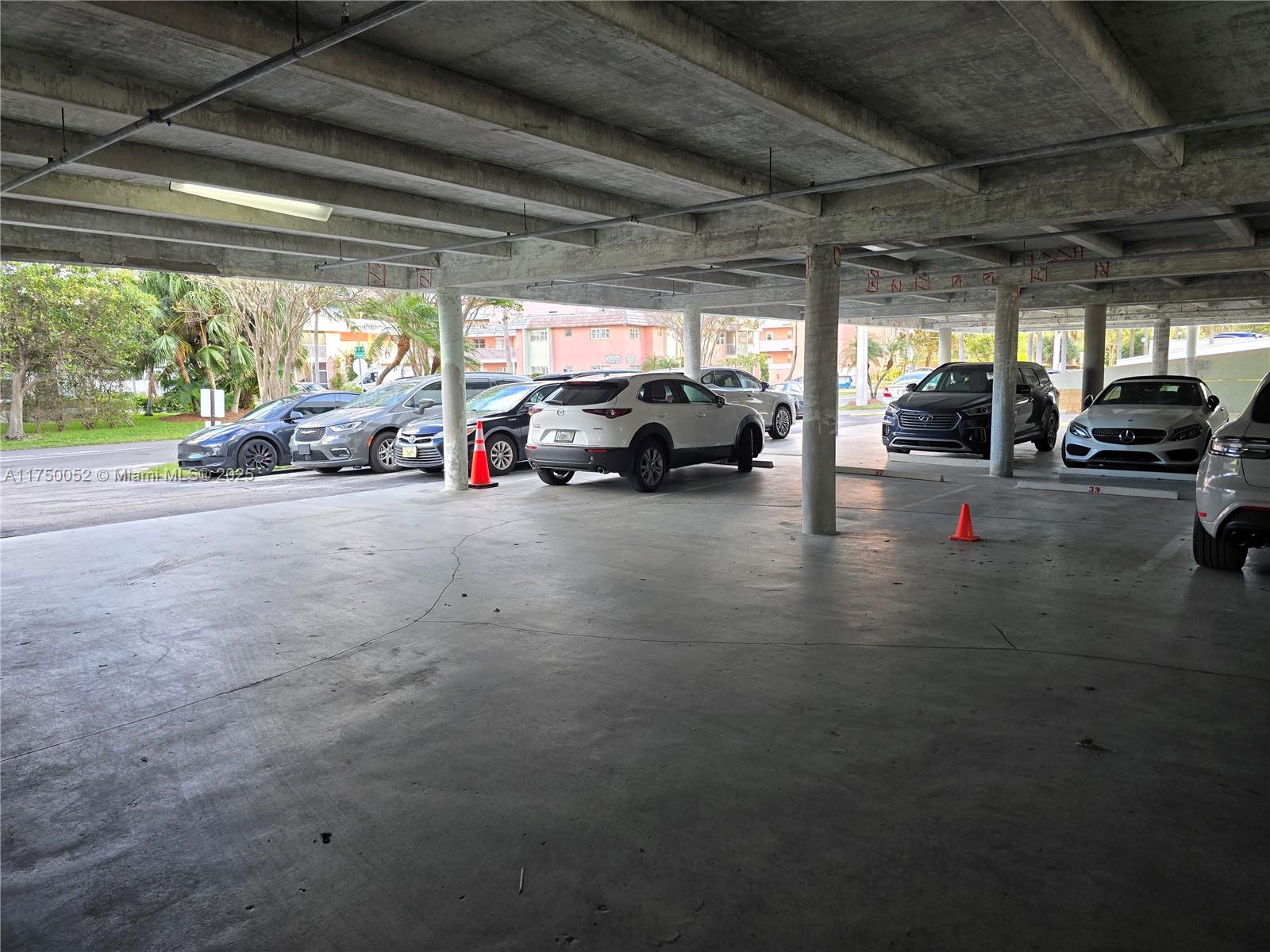 1505 North Riverside Drive, Unit 604 Pompano Beach, FL 33062 - Photo 13 of 50 a view of parking garage with cars parked