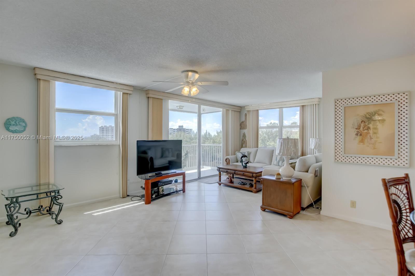 1505 North Riverside Drive, Unit 604 Pompano Beach, FL 33062 - Photo 20 of 50 a living room with furniture and a flat screen tv