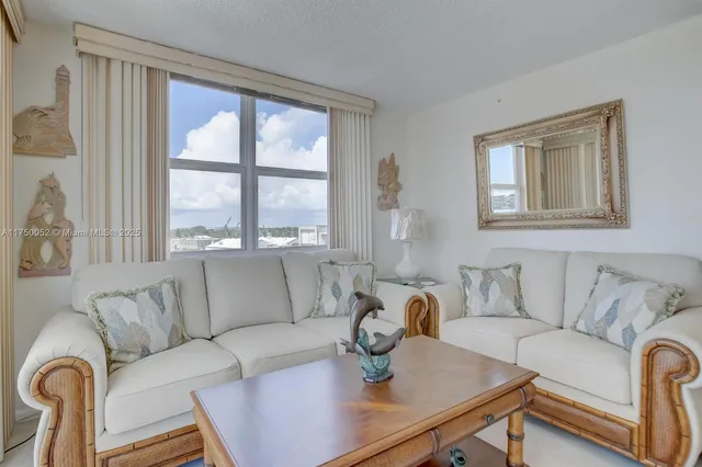 a view of a livingroom with furniture and a view of kitchen
