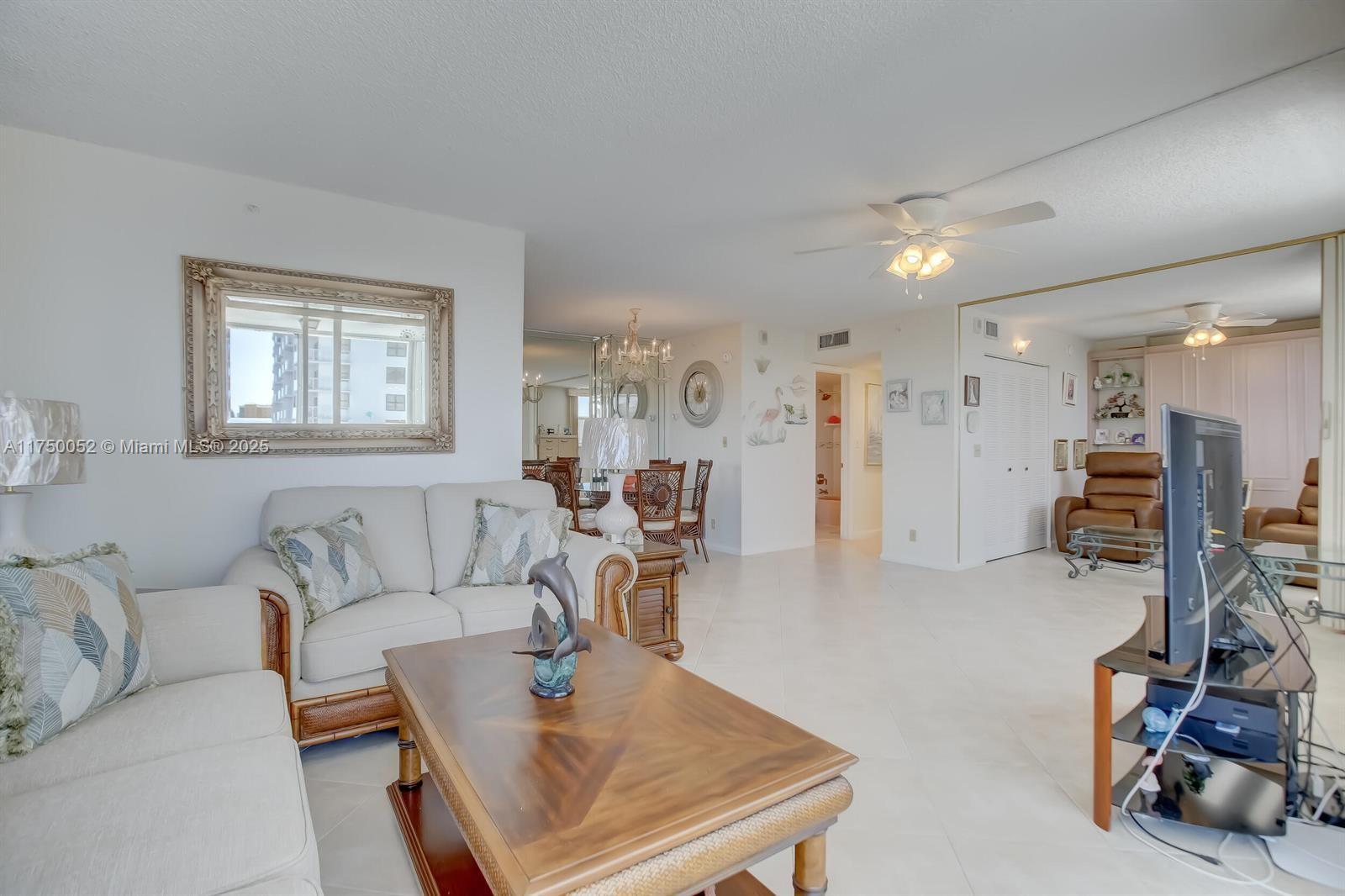 1505 North Riverside Drive, Unit 604 Pompano Beach, FL 33062 - Photo 23 of 50 a living room with furniture and a flat screen tv