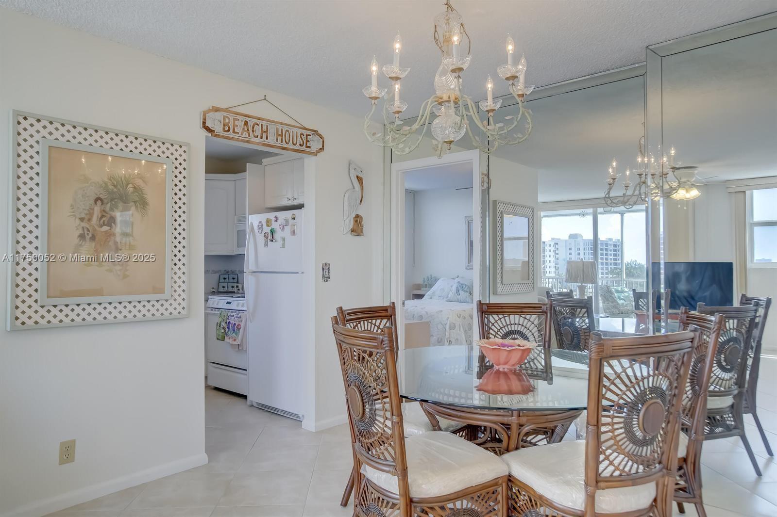 1505 North Riverside Drive, Unit 604 Pompano Beach, FL 33062 - Photo 26 of 50 a view of a dining room with furniture and chandelier