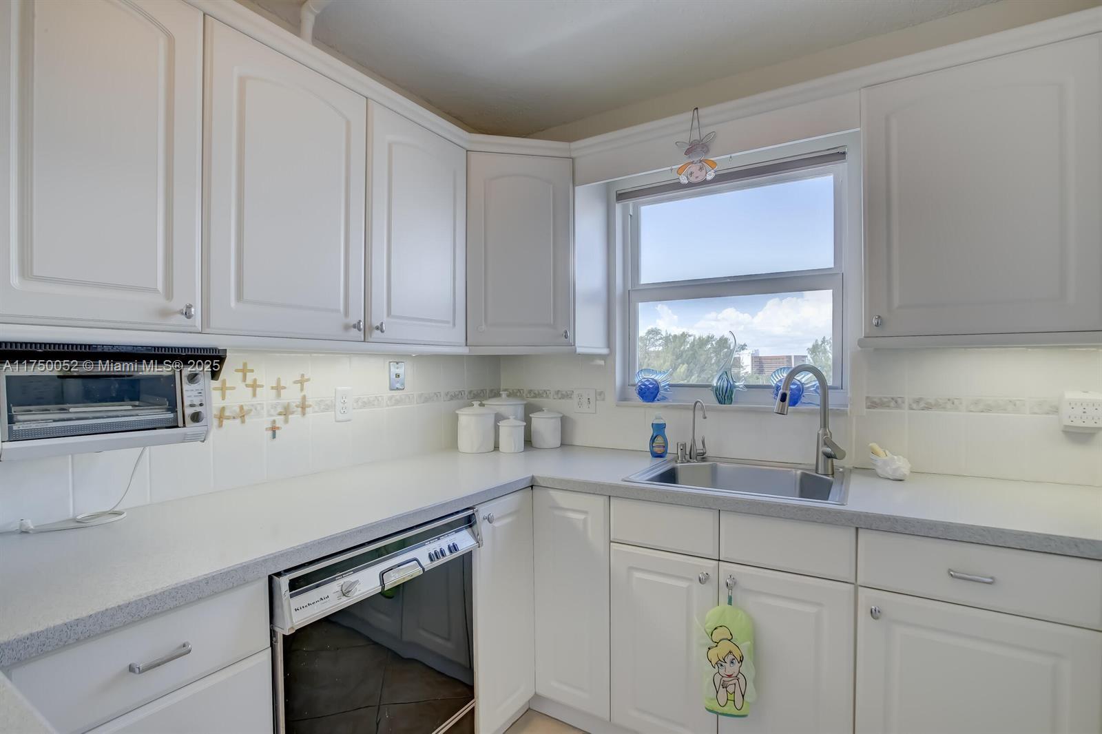 1505 North Riverside Drive, Unit 604 Pompano Beach, FL 33062 - Photo 30 of 50 a kitchen with stainless steel appliances granite countertop a sink window and cabinets