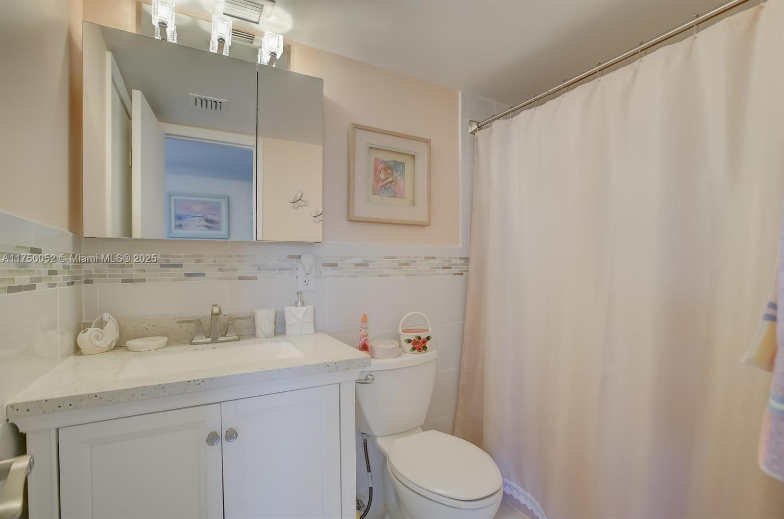 1505 North Riverside Drive, Unit 604 Pompano Beach, FL 33062 - Photo 31 of 50 a bathroom with a sink a toilet and a mirror