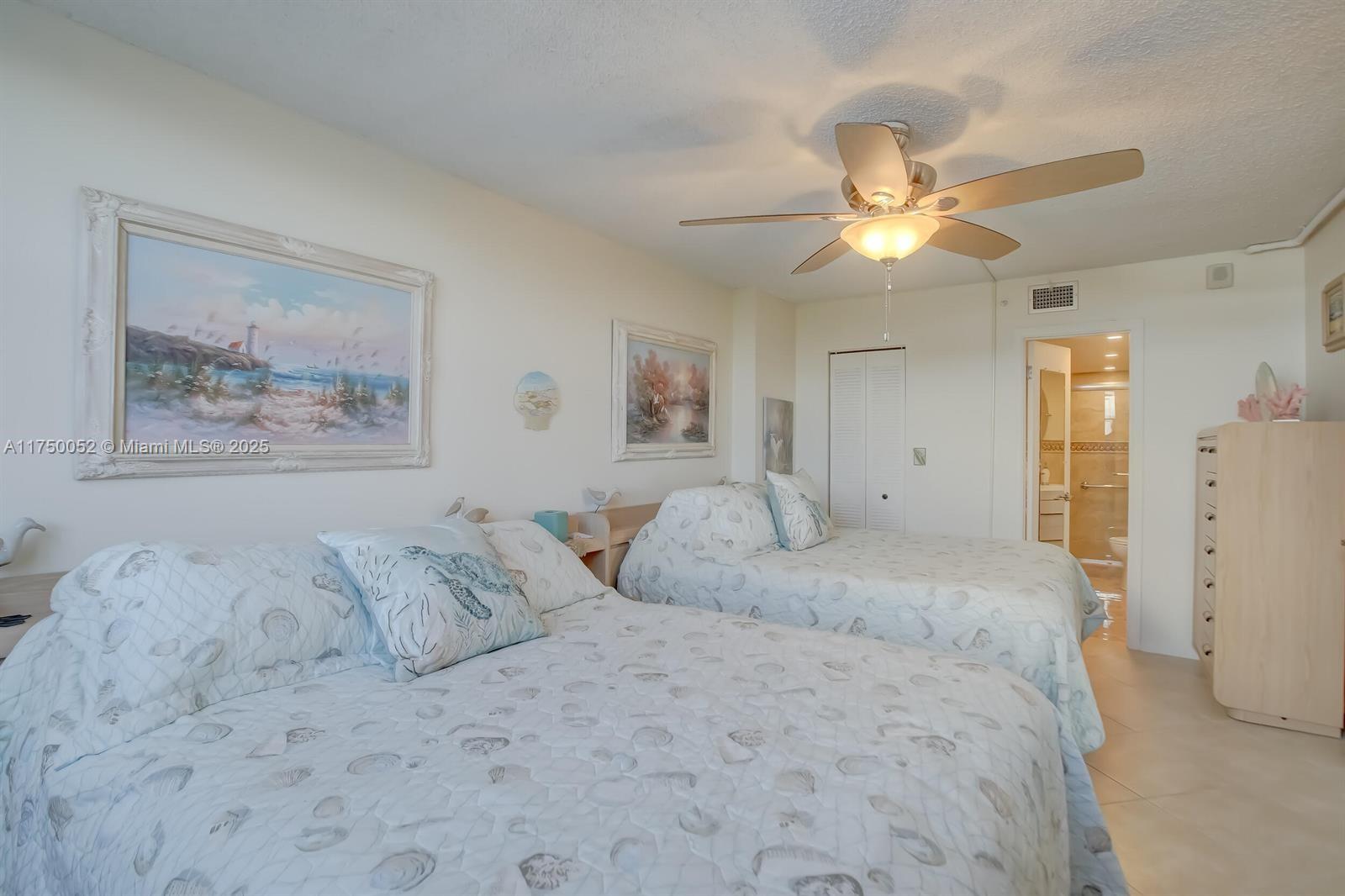 1505 North Riverside Drive, Unit 604 Pompano Beach, FL 33062 - Photo 33 of 50 a bedroom with a bed and a chandelier