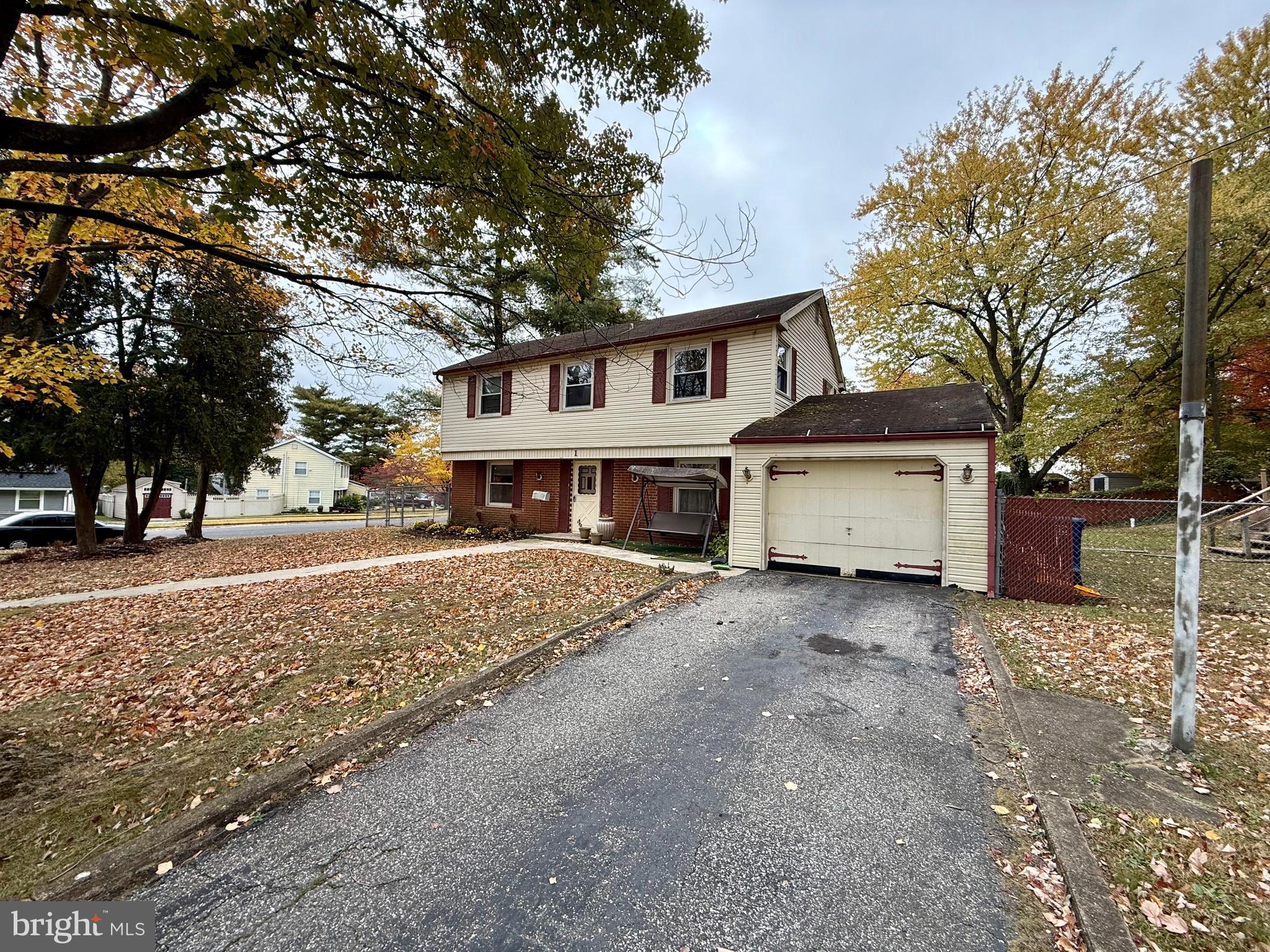 a view of a house with a yard covered with snow in front of house