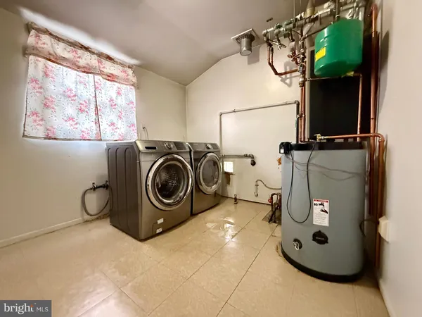 a kitchen with stainless steel appliances a stove a refrigerator a sink a microwave oven with wooden floor and cabinets