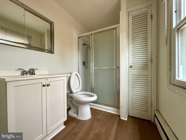 a bathroom with a toilet a sink and mirror