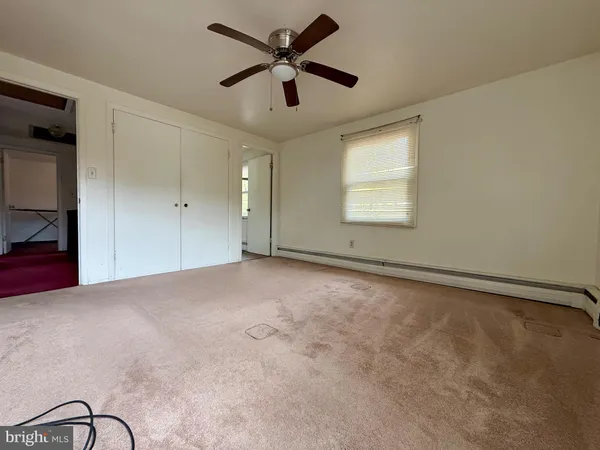 a view of an empty room and a window