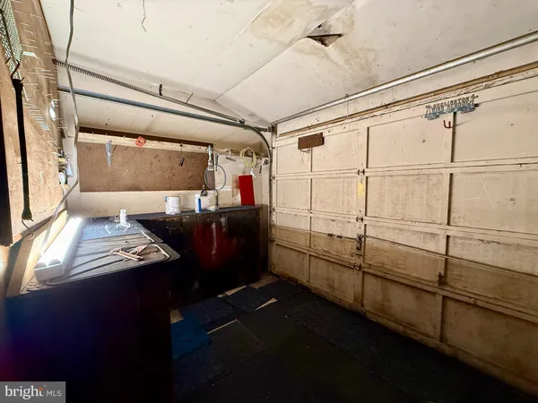 a white house that has a tree in front of it