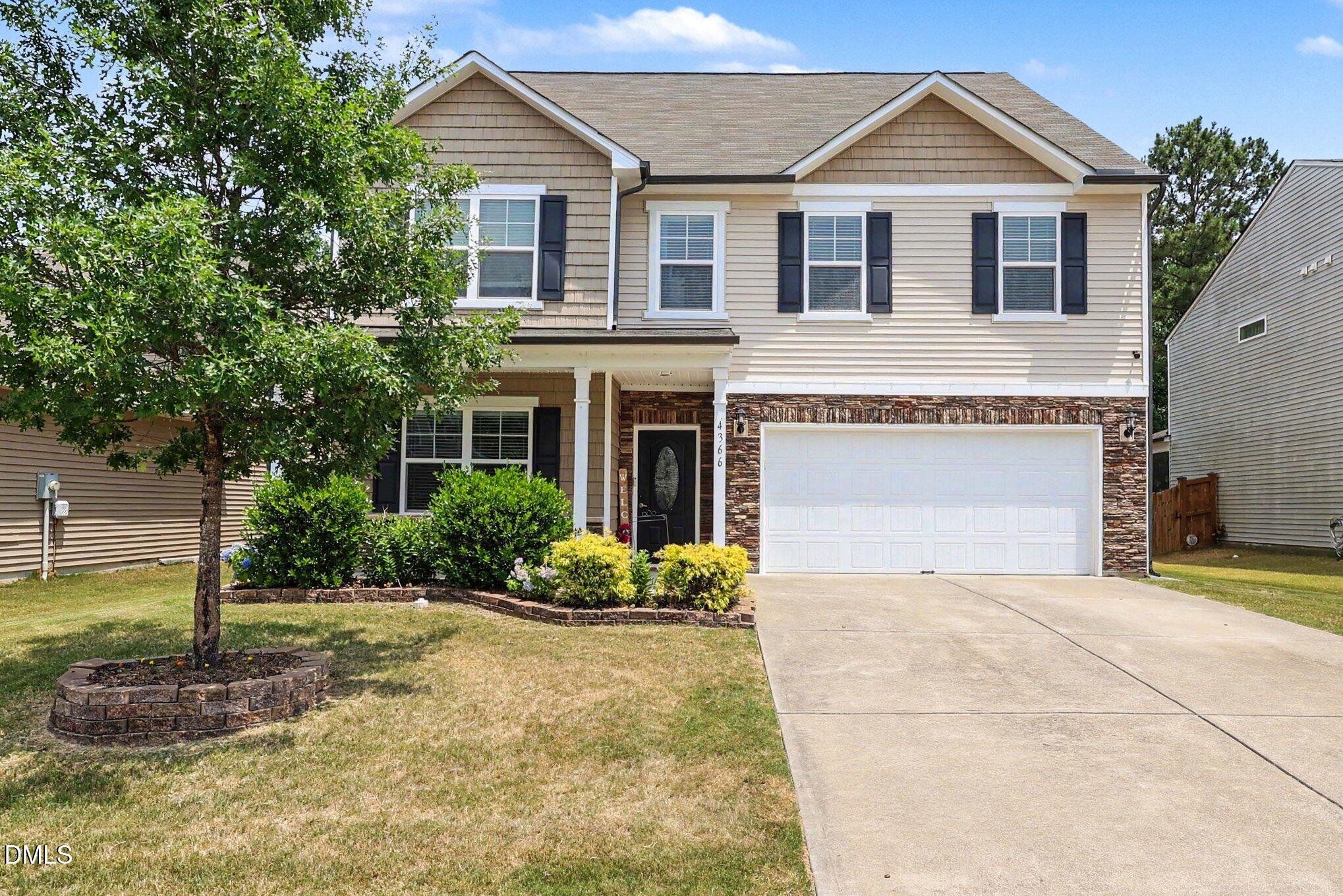 4366 Auburn Hills Drive Raleigh, NC 27616 - Photo 1 of 40 a front view of a house with a yard and garage