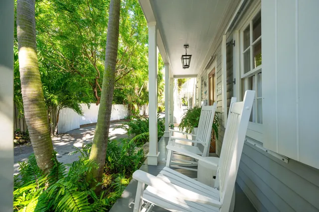 a living room with wooden floor and a dining table
