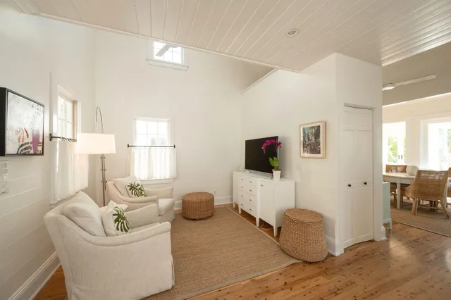 a view of a dining room with furniture a chandelier and wooden floor