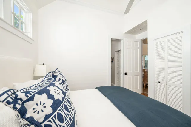 a bedroom with a bed and a large window