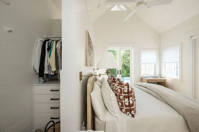 a bedroom with a bed and a painting on the wall