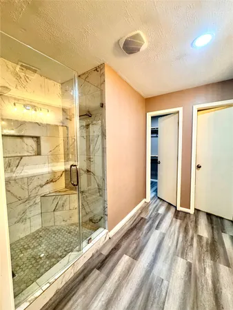 a view of a bathroom with a shower and a sink