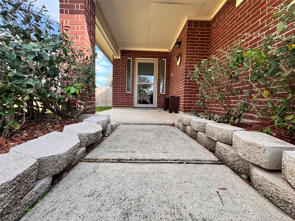 a view of a house with a yard and pathway