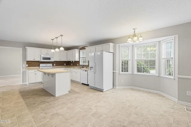 a large kitchen with cabinets and stainless steel appliances