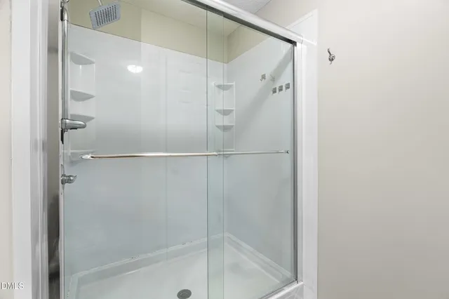 a bathroom with a glass shower door
