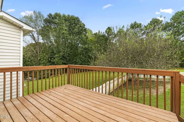 a view of balcony with wooden floor and fence