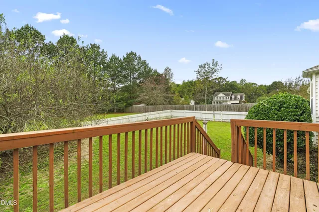 a view of balcony with wooden floor and fence