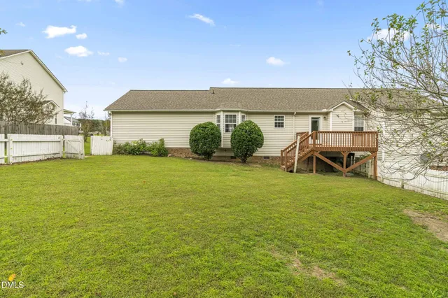 a backyard of a house with table and chairs