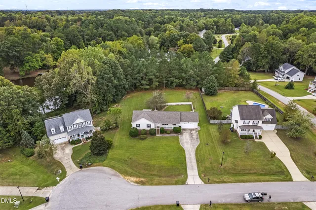 an aerial view of a house with a garden and houses