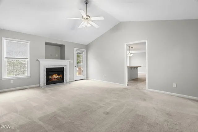 a view of a livingroom with an empty space and a fireplace