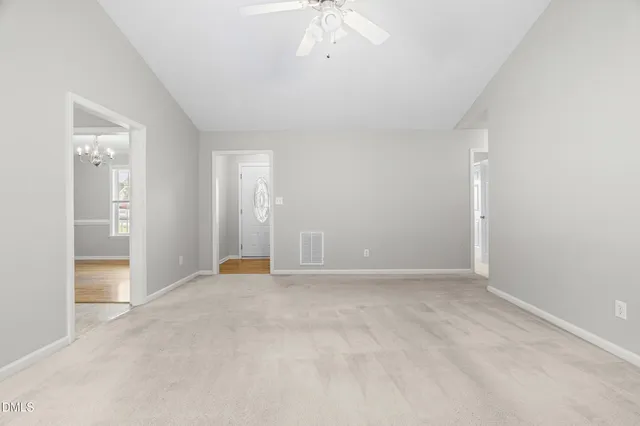 an empty room with fan and entrance