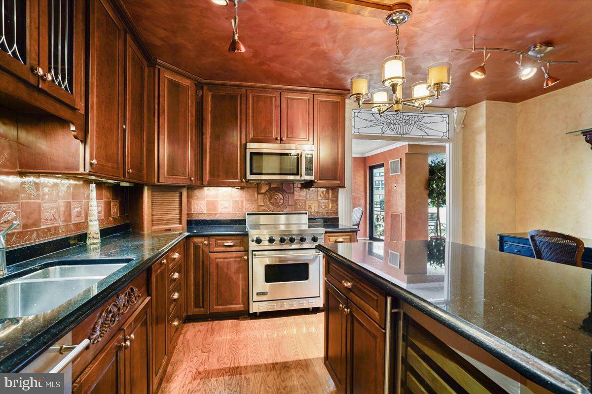 800 25th Street Northwest, Unit 504 Washington, DC 20037 - Photo 20 of 52 Elegant kitchen with rich wood tones.