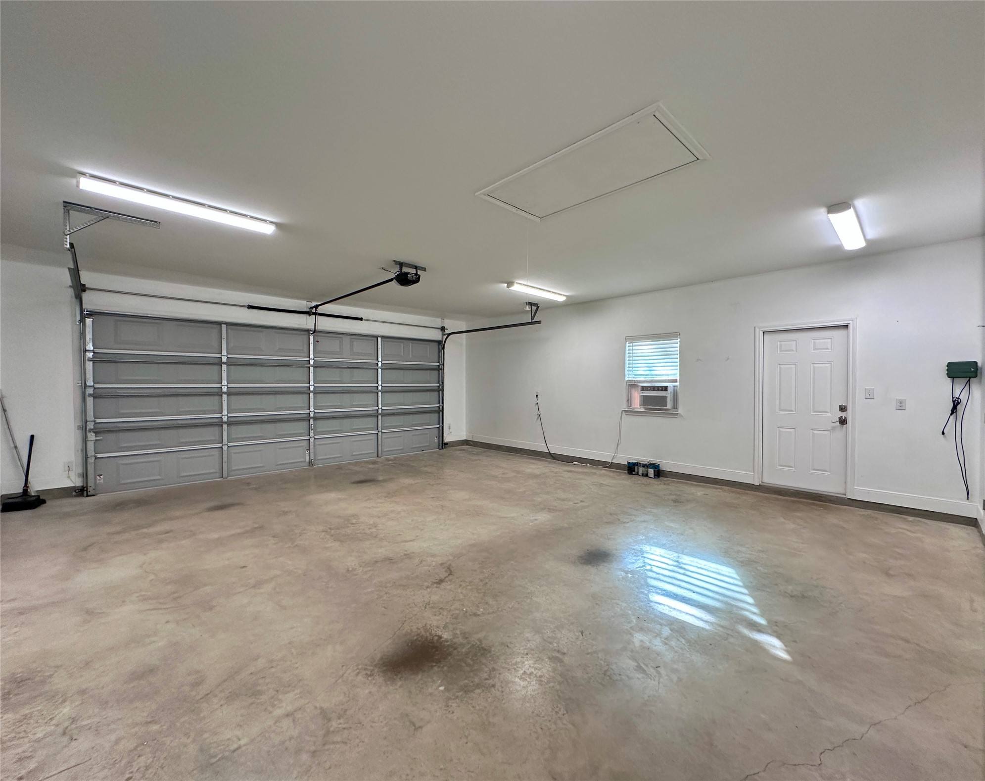 124 Pine Path Bastrop, TX 78602 - Photo 30 of 31 Garage featuring storage and cooling unit