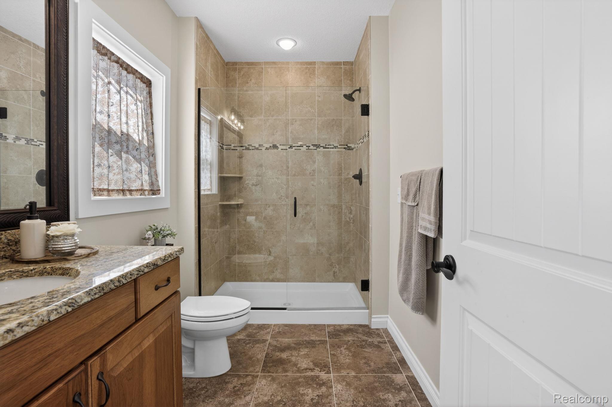 101 Highview Road Traverse City, MI 49696 - Photo 64 of 88 Full bathroom with vanity and a shower stall