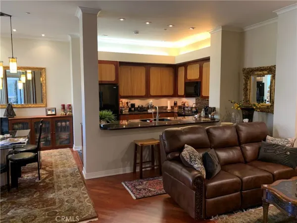 a living room with furniture and kitchen view