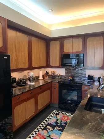 a kitchen with stainless steel appliances granite countertop a stove sink and cabinets