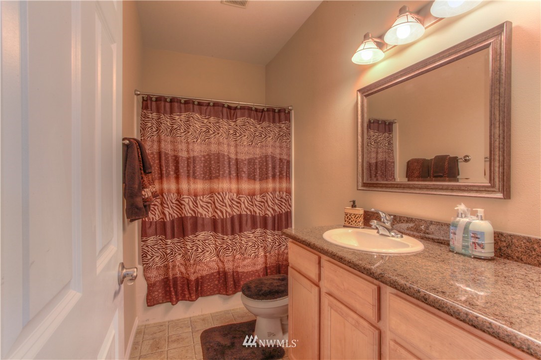 51 Pinehurst Loop Sequim, WA 98382 - Photo 13 of 24 a bathroom with a sink and a mirror