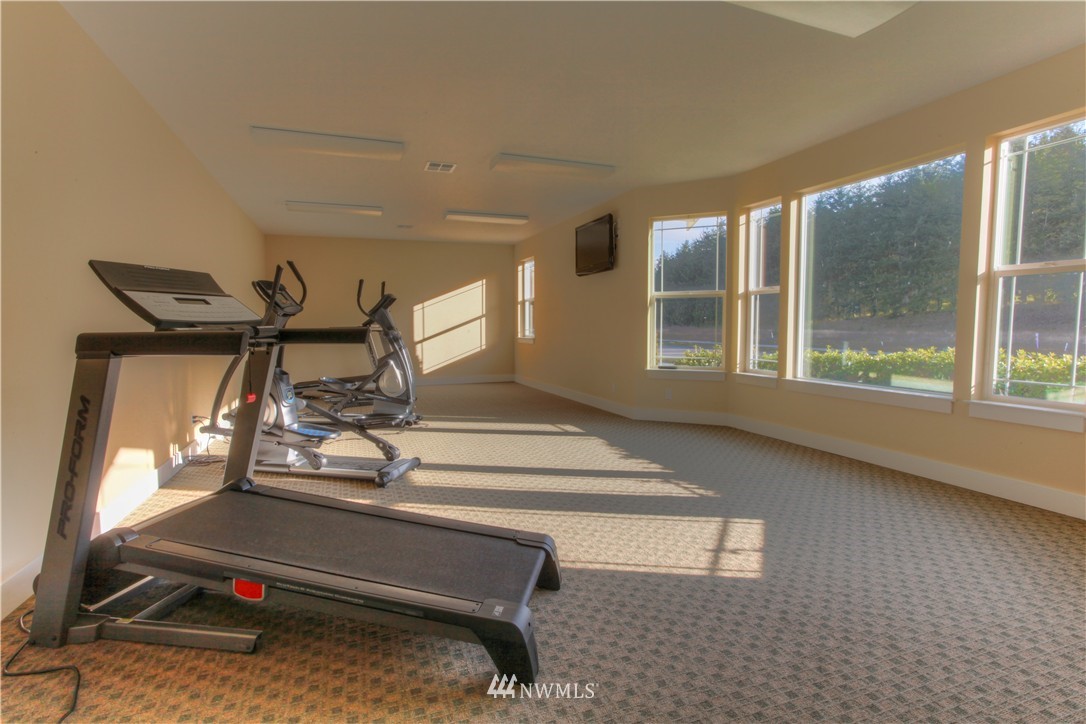 51 Pinehurst Loop Sequim, WA 98382 - Photo 17 of 24 a room with gym equipment and large windows