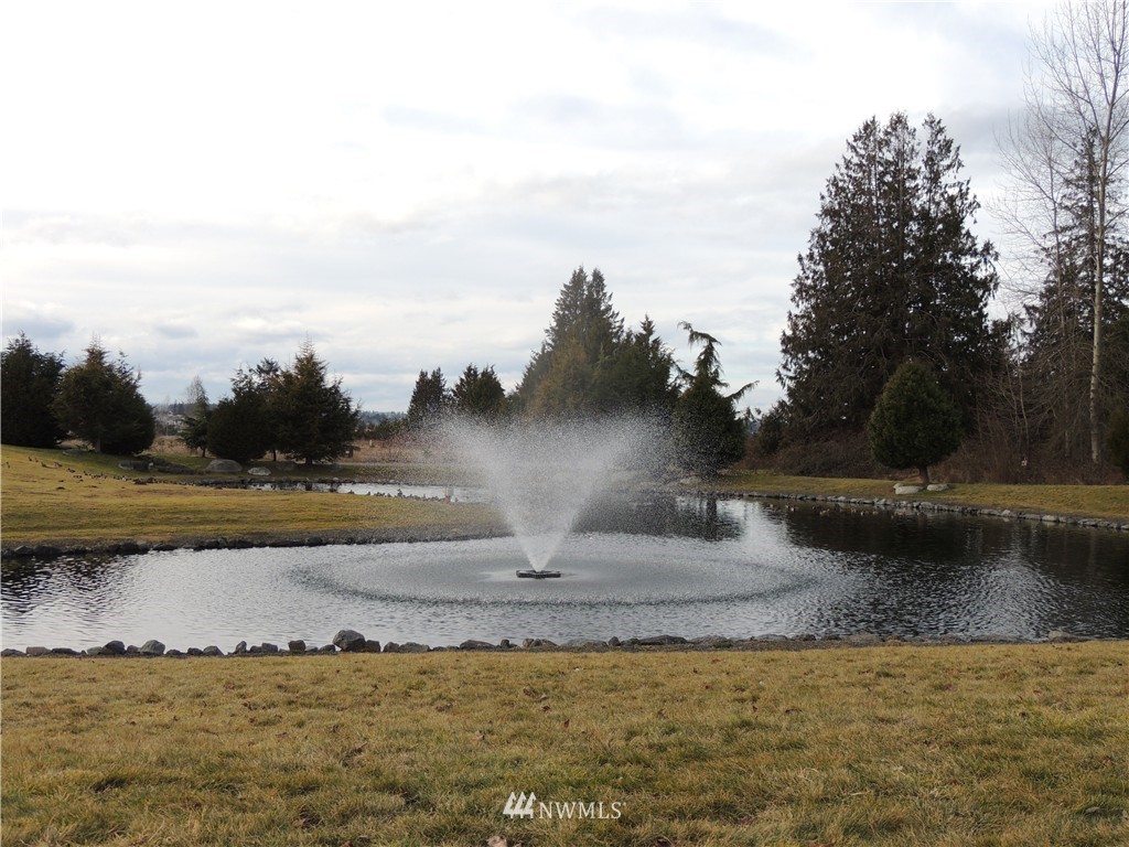 51 Pinehurst Loop Sequim, WA 98382 - Photo 20 of 24 a view of a lake with houses in the back