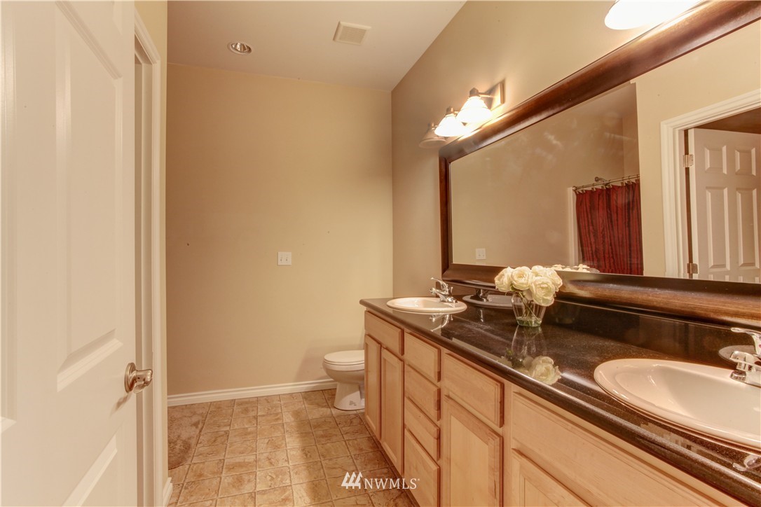 51 Pinehurst Loop Sequim, WA 98382 - Photo 9 of 24 a bathroom with a sink a toilet and mirror