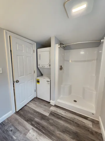 a view of a bathroom with shower and bathtub