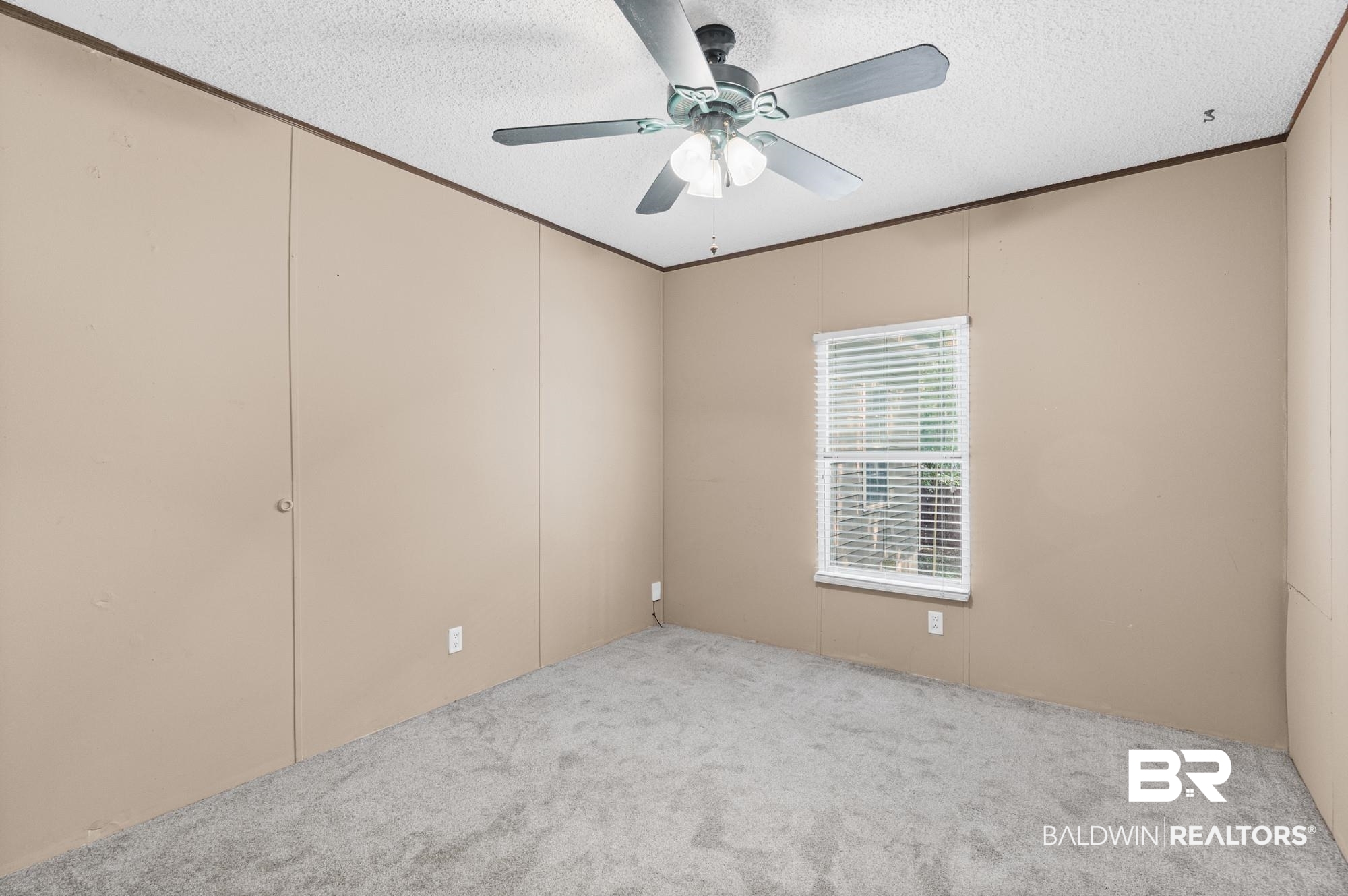 8675 Hunters Pointe Drive North Theodore, AL 36582 - Photo 15 of 20 Neutral-toned walls complement the gray carpeting