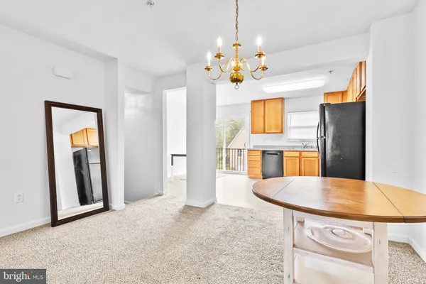 a view of a dining room with furniture and chandelier